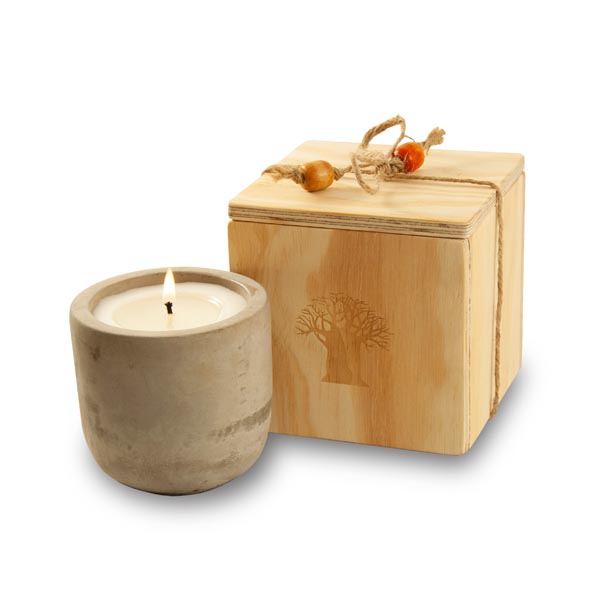 candle in raw cement holder packed in wooden box